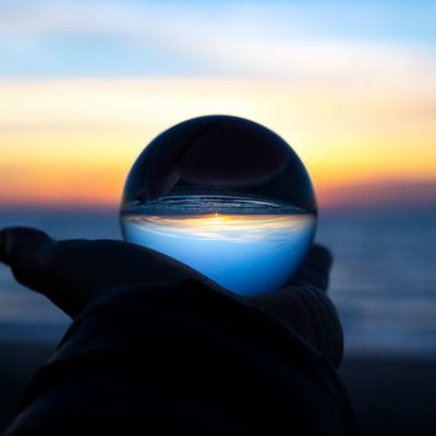 Hand holding a glass ball