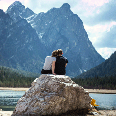 young couple outside looking at a mountain