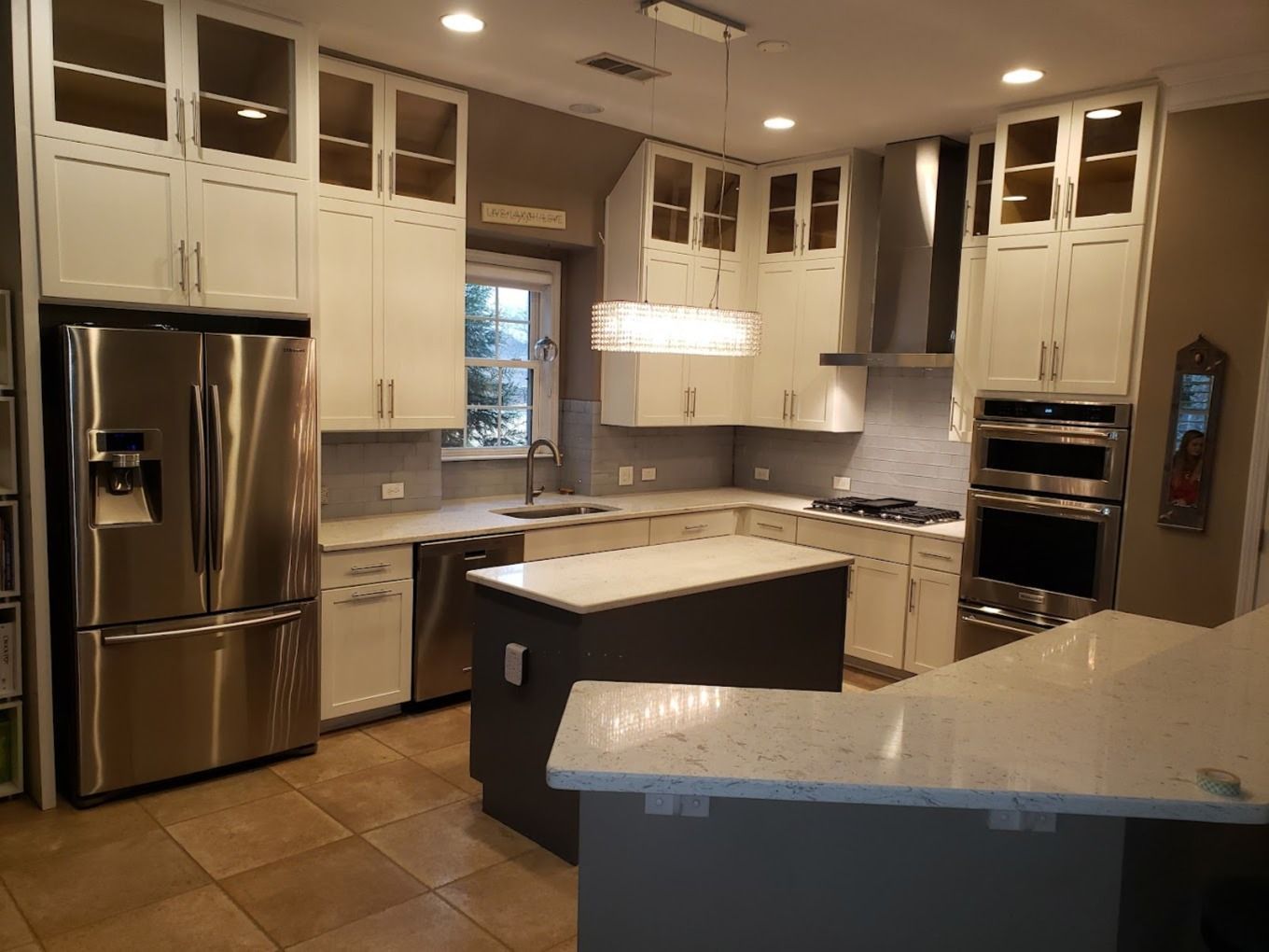 a kitchen with stainless steel appliances and white cabinets