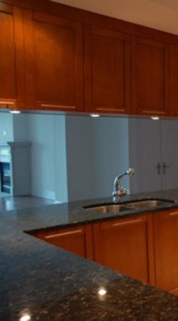 A kitchen with a sink and wooden cabinets