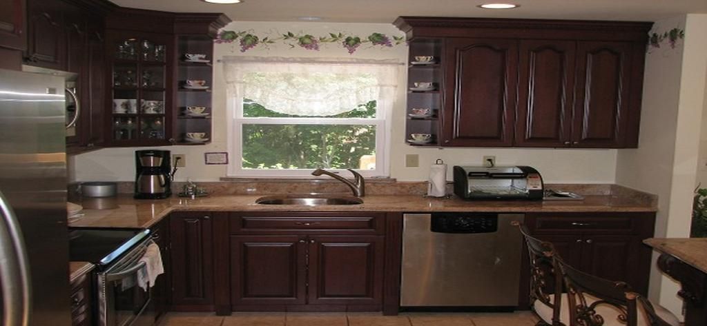 A kitchen with brown cabinets and stainless steel appliances