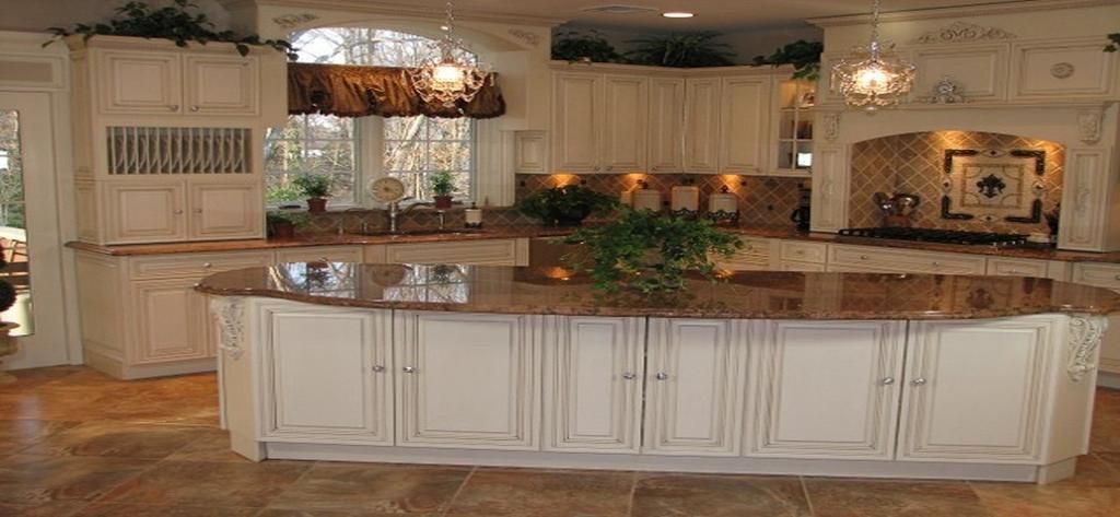 A kitchen with a large island and white cabinets
