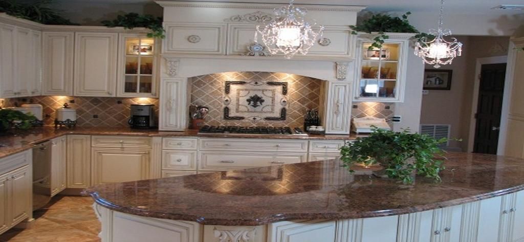 A kitchen with white cabinets and granite counter tops