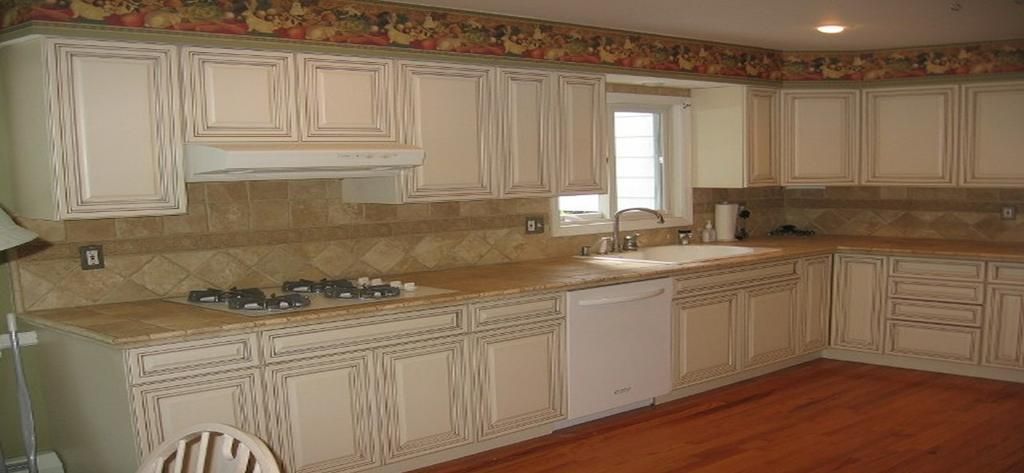 A kitchen with white cabinets and granite counter tops