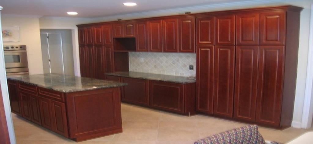 A kitchen with wooden cabinets and granite counter tops