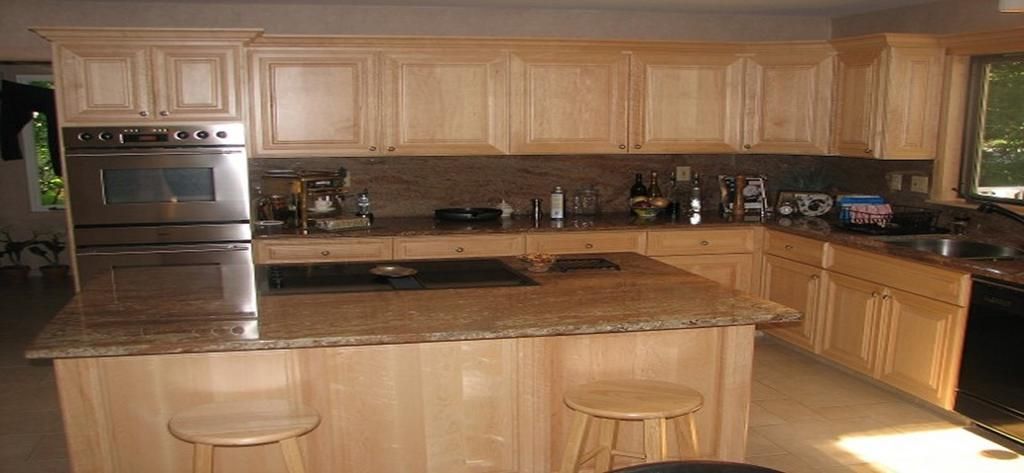 A kitchen with wooden cabinets and granite counter tops