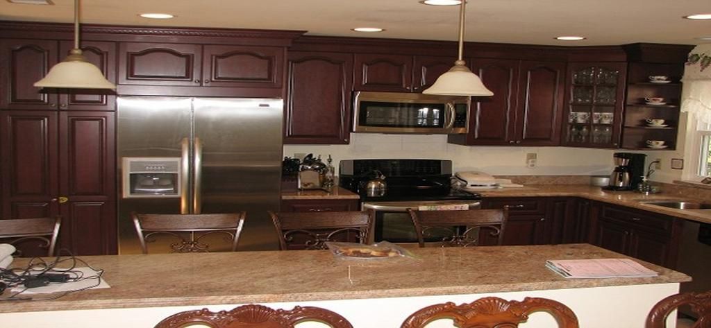 A kitchen with stainless steel appliances and wooden cabinets