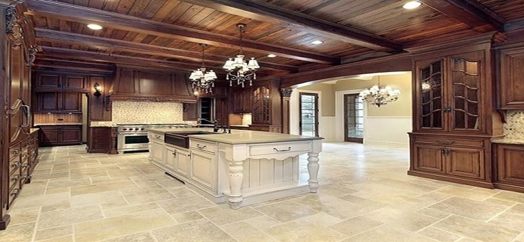 A large kitchen with a large island in the middle and a wooden ceiling.