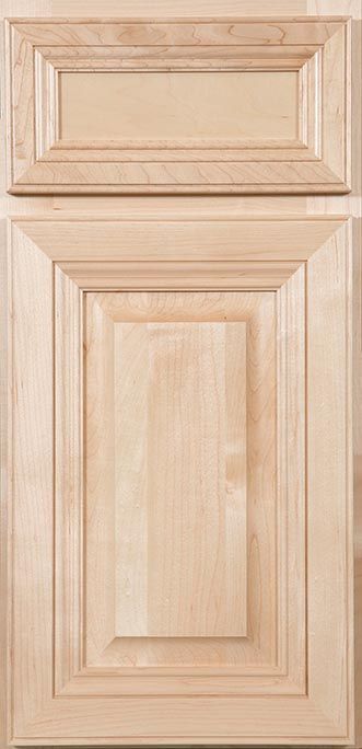 A close up of a wooden cabinet door on a table.