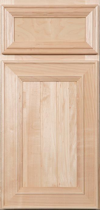 A close up of a wooden cabinet door with a drawer