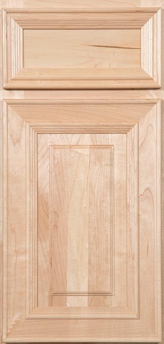 A close up of a wooden cabinet door on a table.