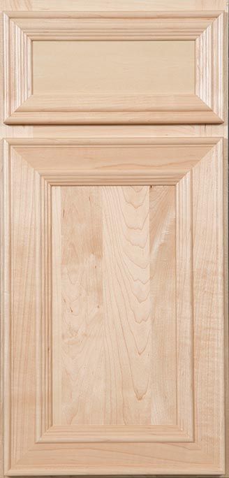 A close up of a wooden cabinet door with a drawer.