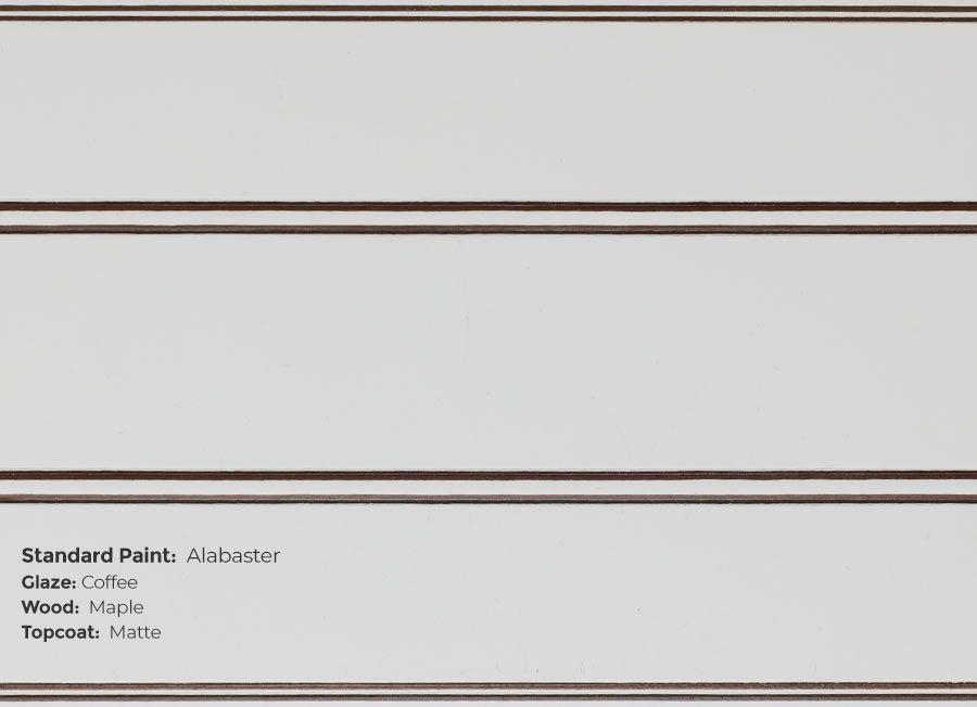 A close up of a white cabinet with a brown trim.