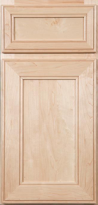A close up of a wooden cabinet door with a drawer.