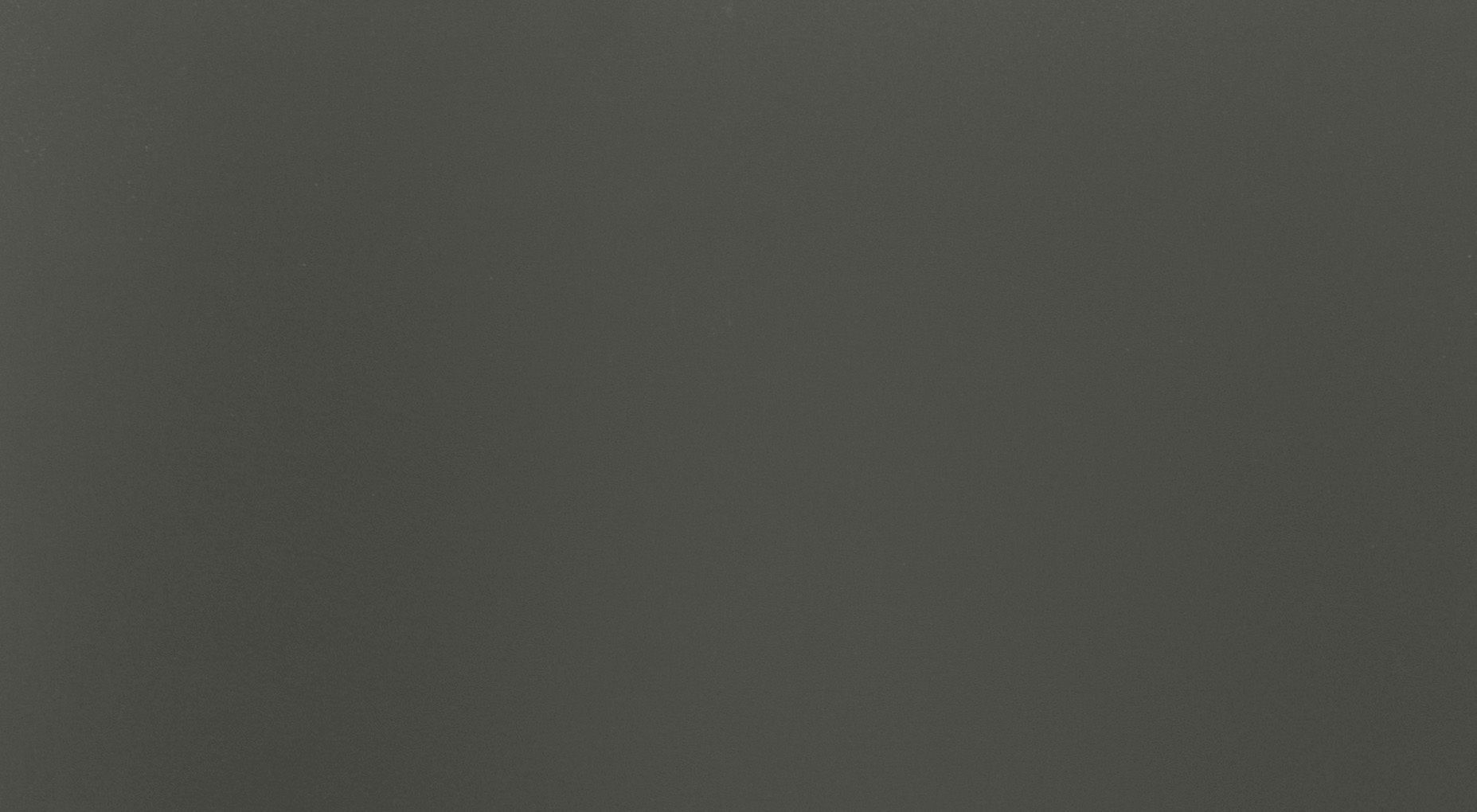 Solid dark gray background with textured surface.