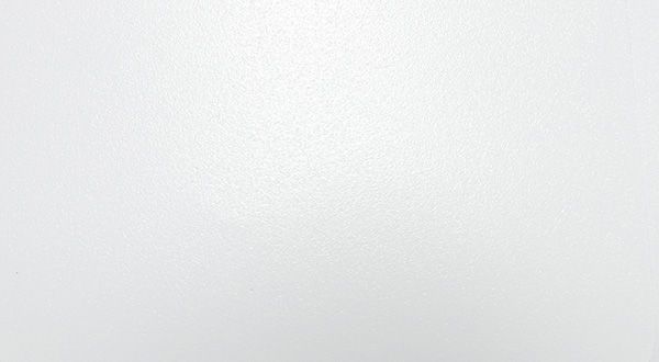 White wall, slightly textured, with a subtle gradient.