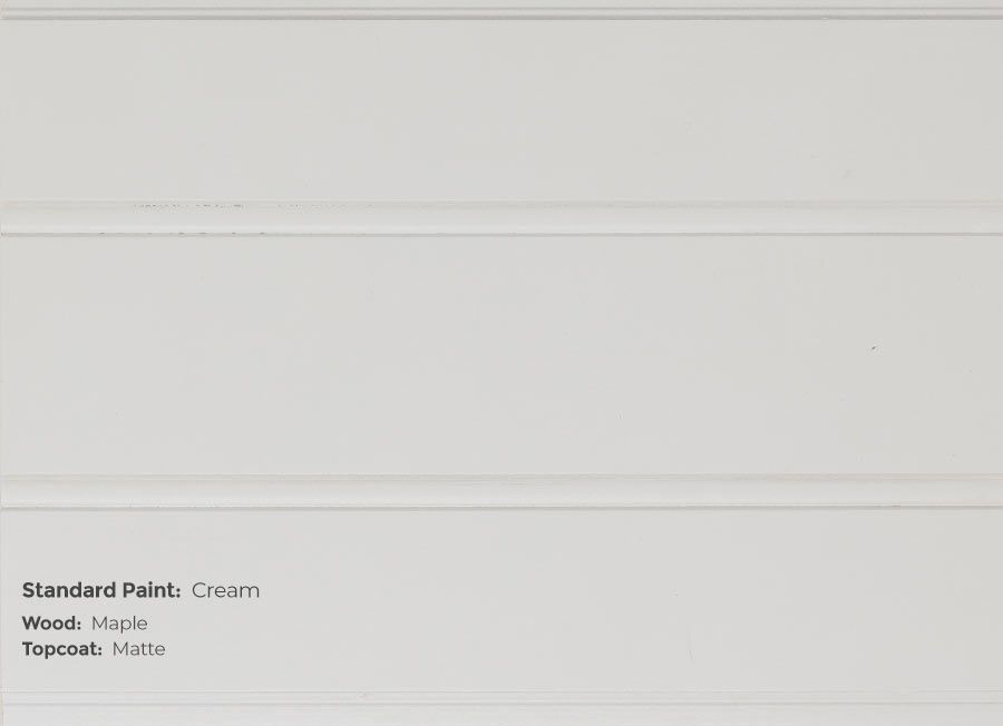 A close up of a white wall with the words standard paint cream on it.