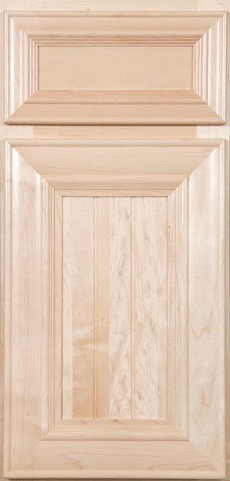 A close up of a wooden cabinet door on a kitchen counter.