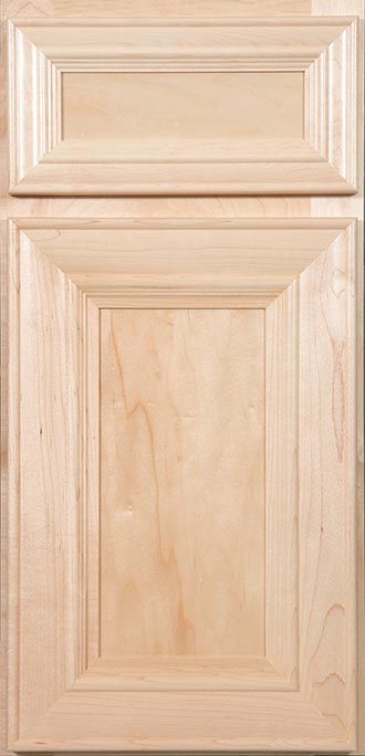 A close up of a wooden cabinet door on a counter.