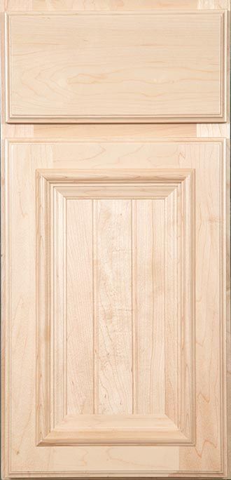 A close up of a wooden cabinet door with a drawer.