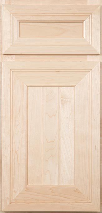 A close up of a wooden cabinet door on a table.