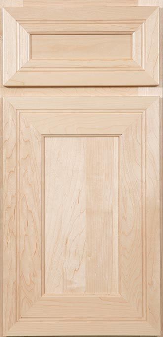 A close up of a wooden cabinet door on a kitchen counter.