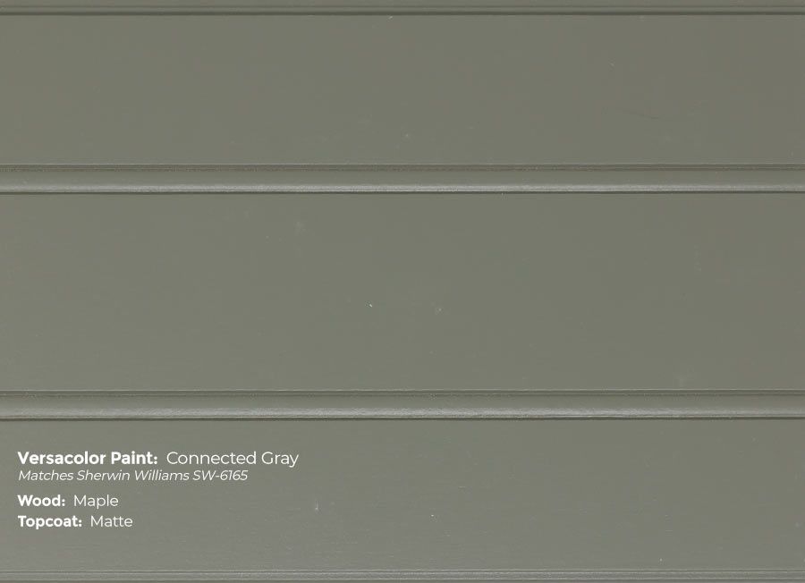 A close up of a wall with a gray paint.