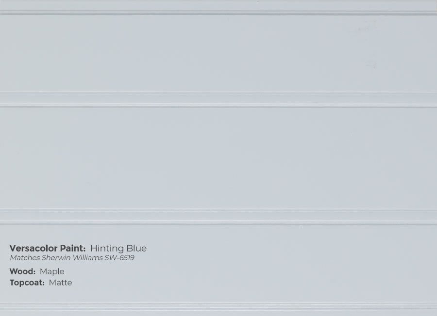 A close up of a white wall with a paint swatch on it.