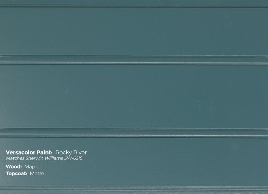 A close up of a piece of blue paint on a white surface.