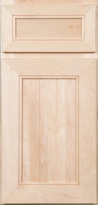 A close up of a wooden cabinet door on a white surface.