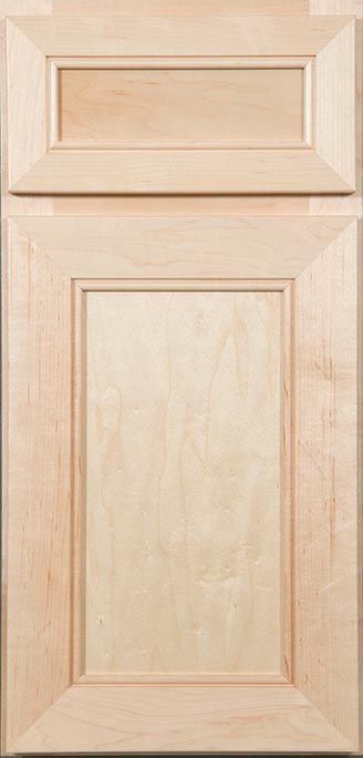 A close up of a wooden cabinet door on a table.