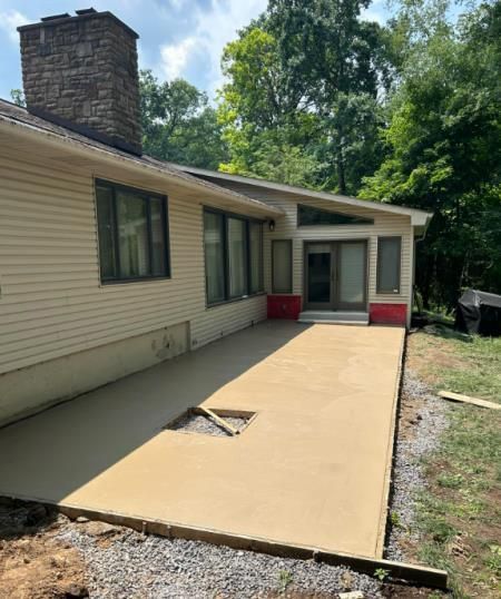 A house with a concrete patio in front of it.