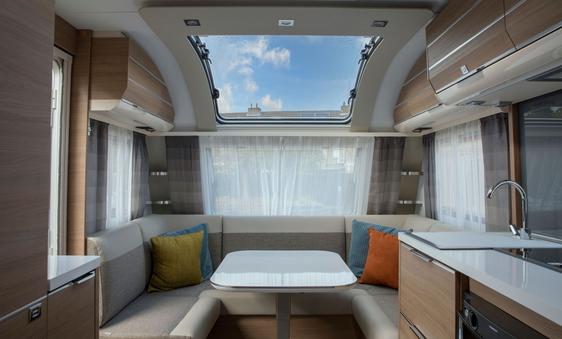 A Interior of a Modern Caravan With a Dining Area — Cupitt's Quality Upholstery in Yamba, NSW