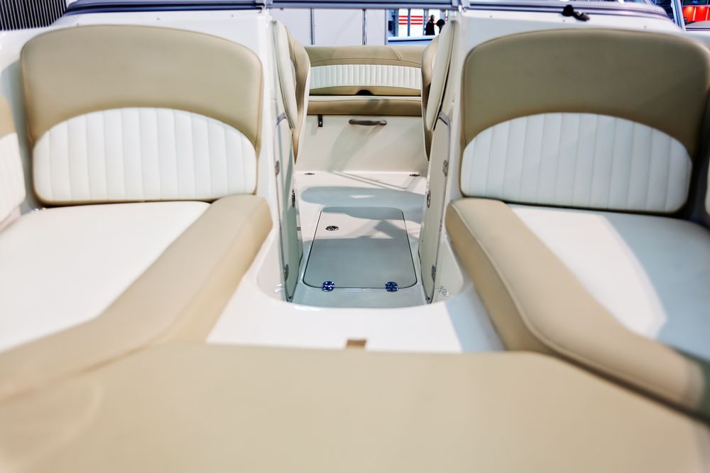 A Boat Interior With Tan and White Seats — Cupitt's Quality Upholstery in Rous, NSW