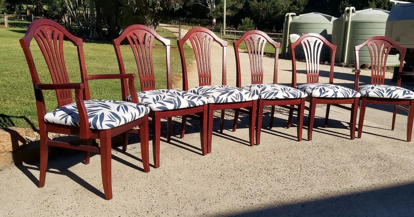 A Six Dining Chairs With Red Frames and Patterned Cushions — Cupitt's Quality Upholstery in Byron Bay, NSW