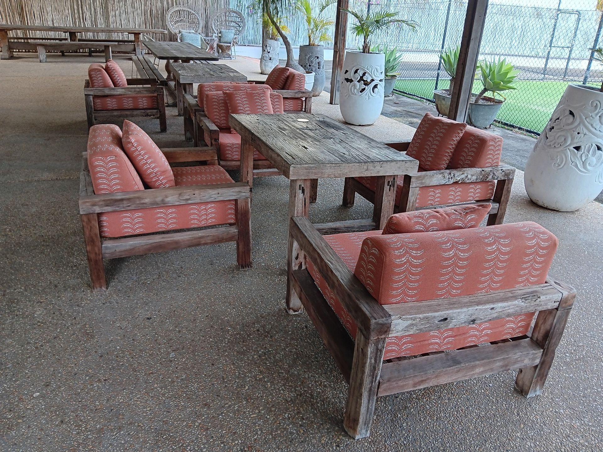 A Outdoor Seating Area With Wooden Tables and Chairs — Cupitt's Quality Upholstery in Rous, NSW