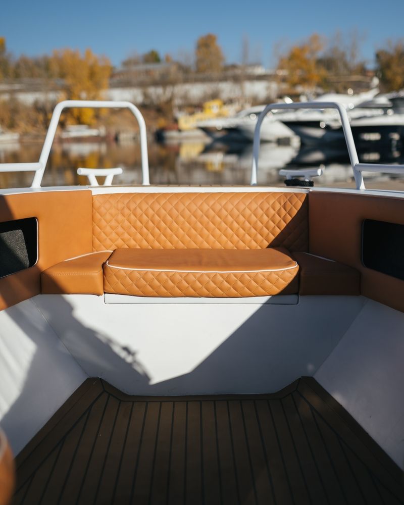 A Boat Interior With Brown Quilted Cushions — Cupitt's Quality Upholstery in Yamba, NSW