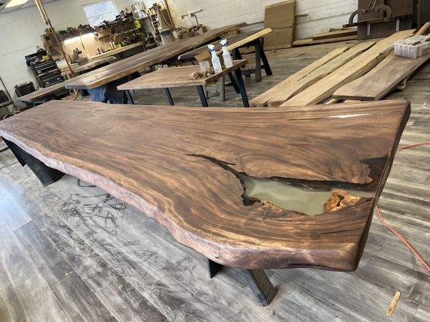 A large wooden table with a hole in the middle is sitting in a room.