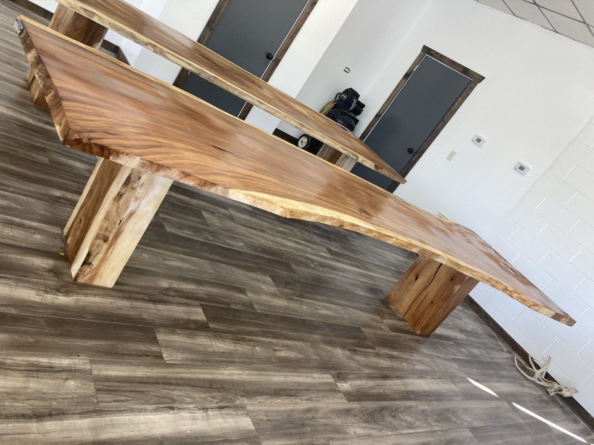 A wooden table is sitting on a wooden floor in a room.