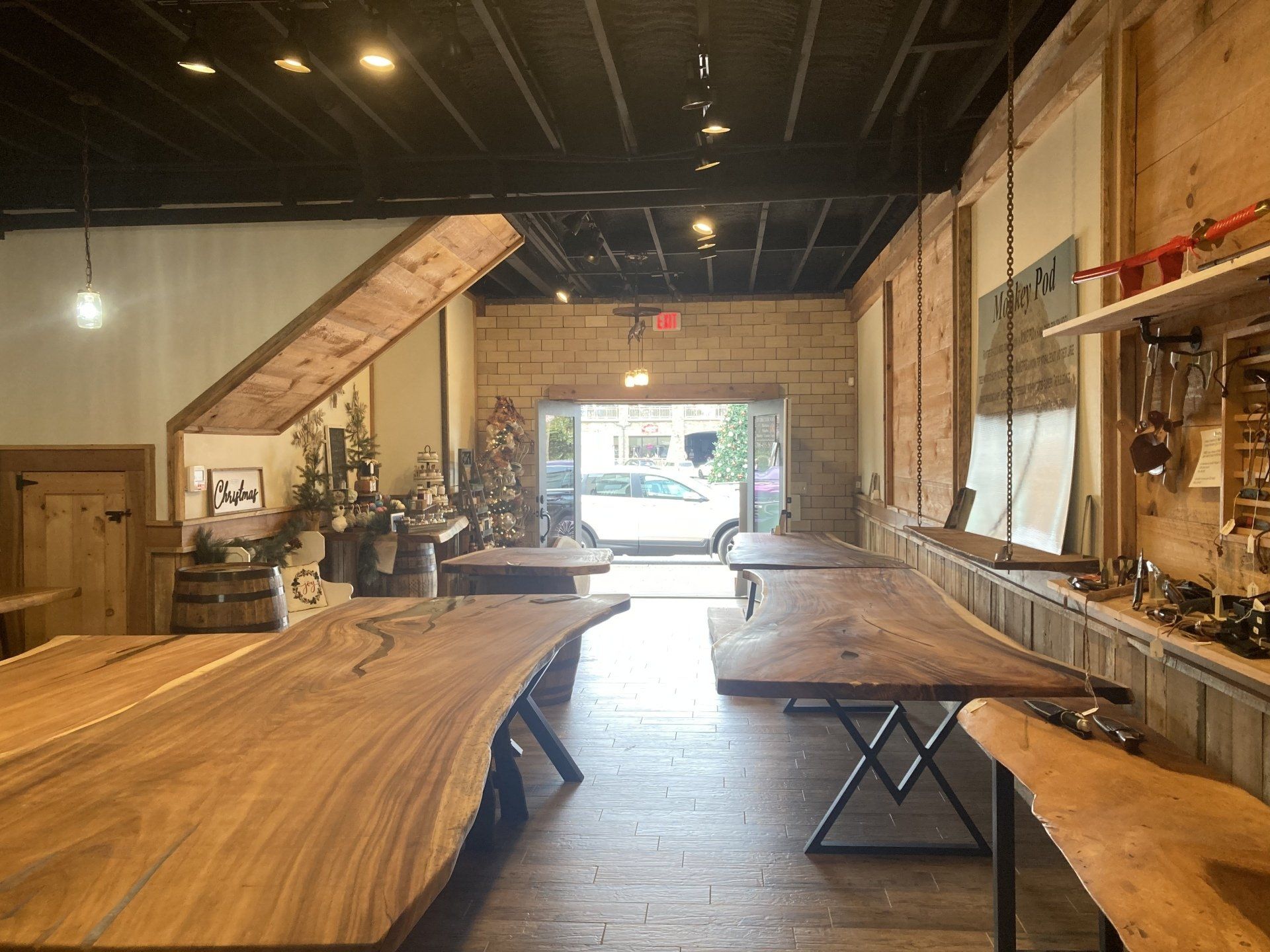 A room with a lot of wooden tables in it