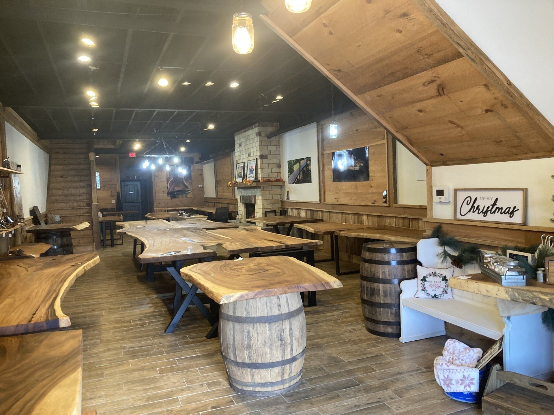 A large room filled with wooden tables and barrels.