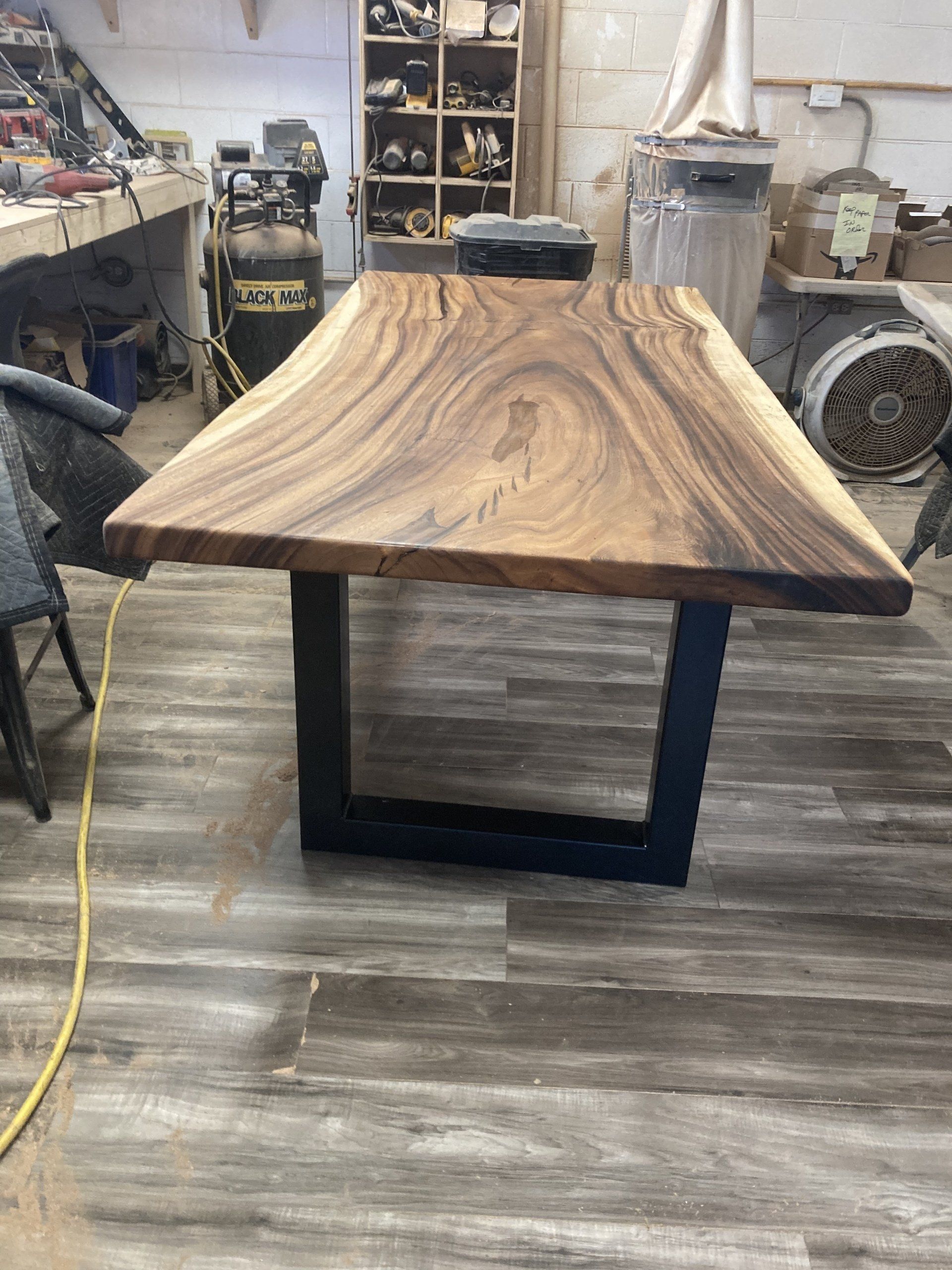 A wooden table is sitting on a wooden floor in a room.