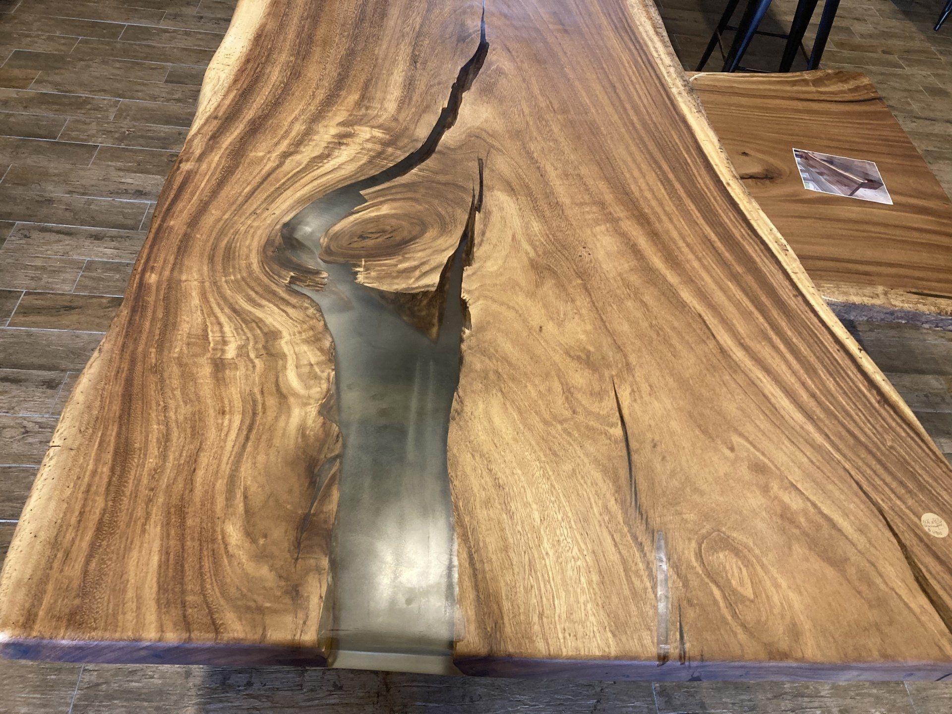 A wooden table with a river in the middle of it.