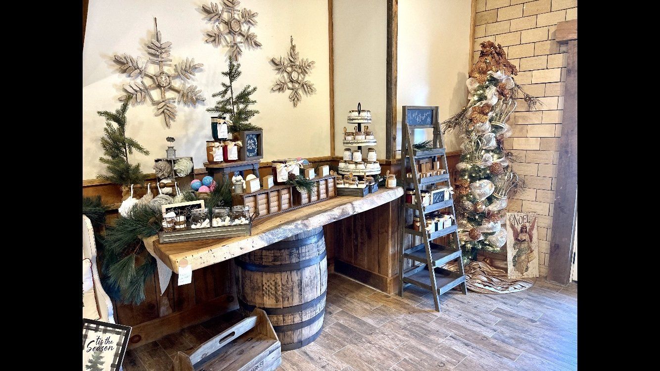 A room filled with lots of christmas decorations and a wooden table.