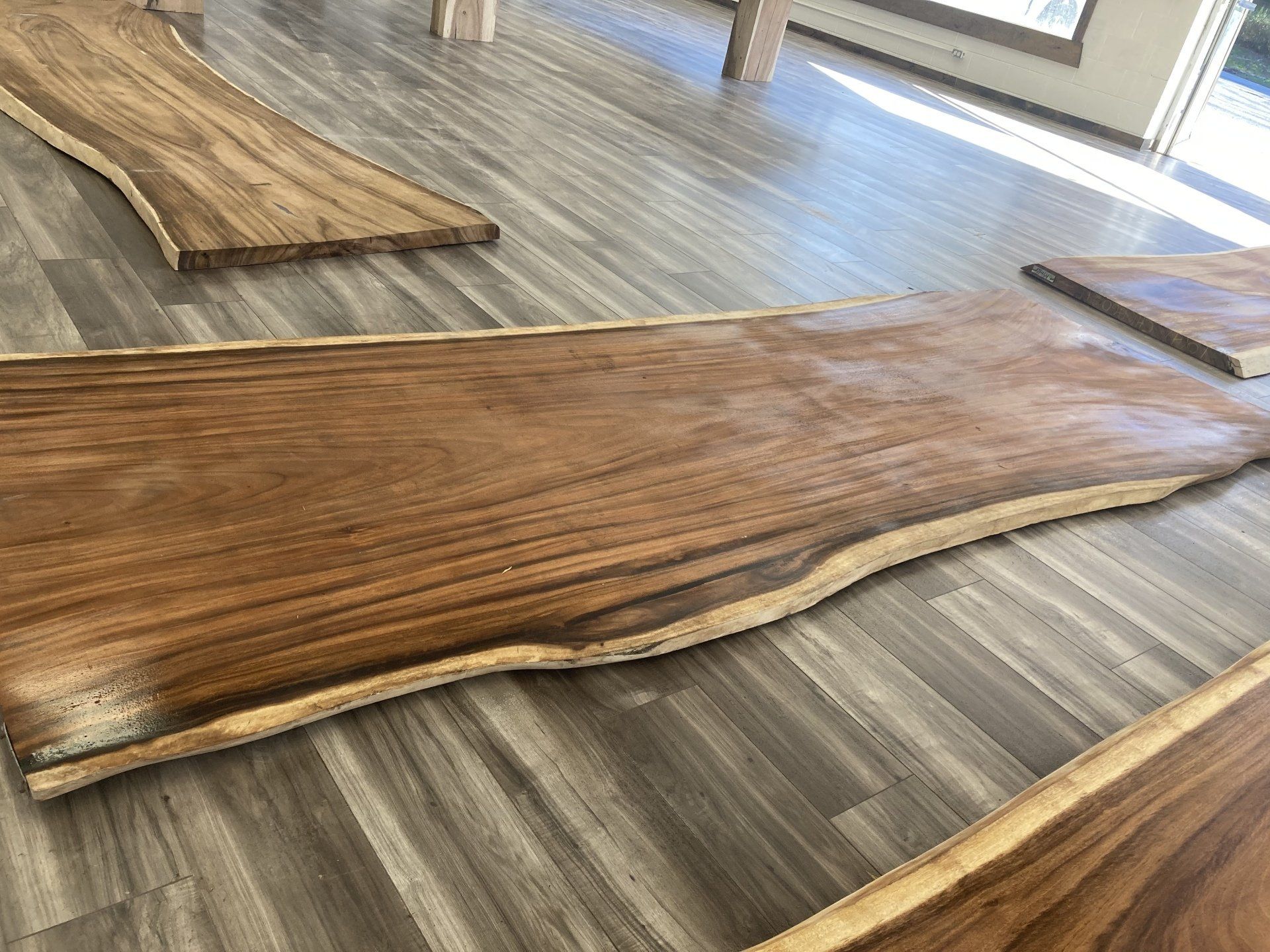 A wooden cutting board is sitting on a wooden floor.