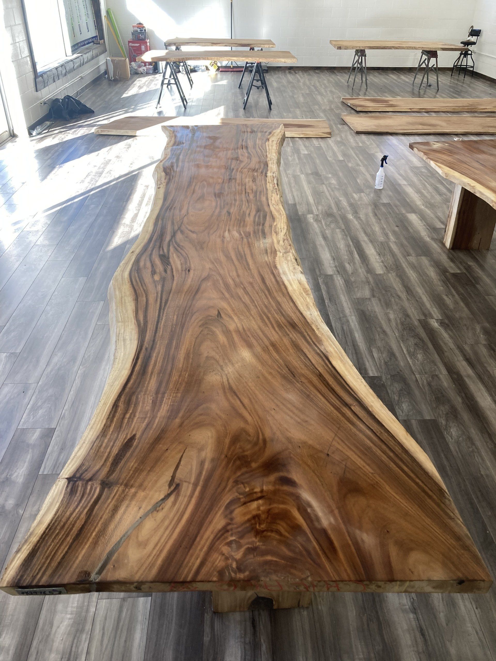 A large piece of wood is sitting on top of a wooden floor in a room.