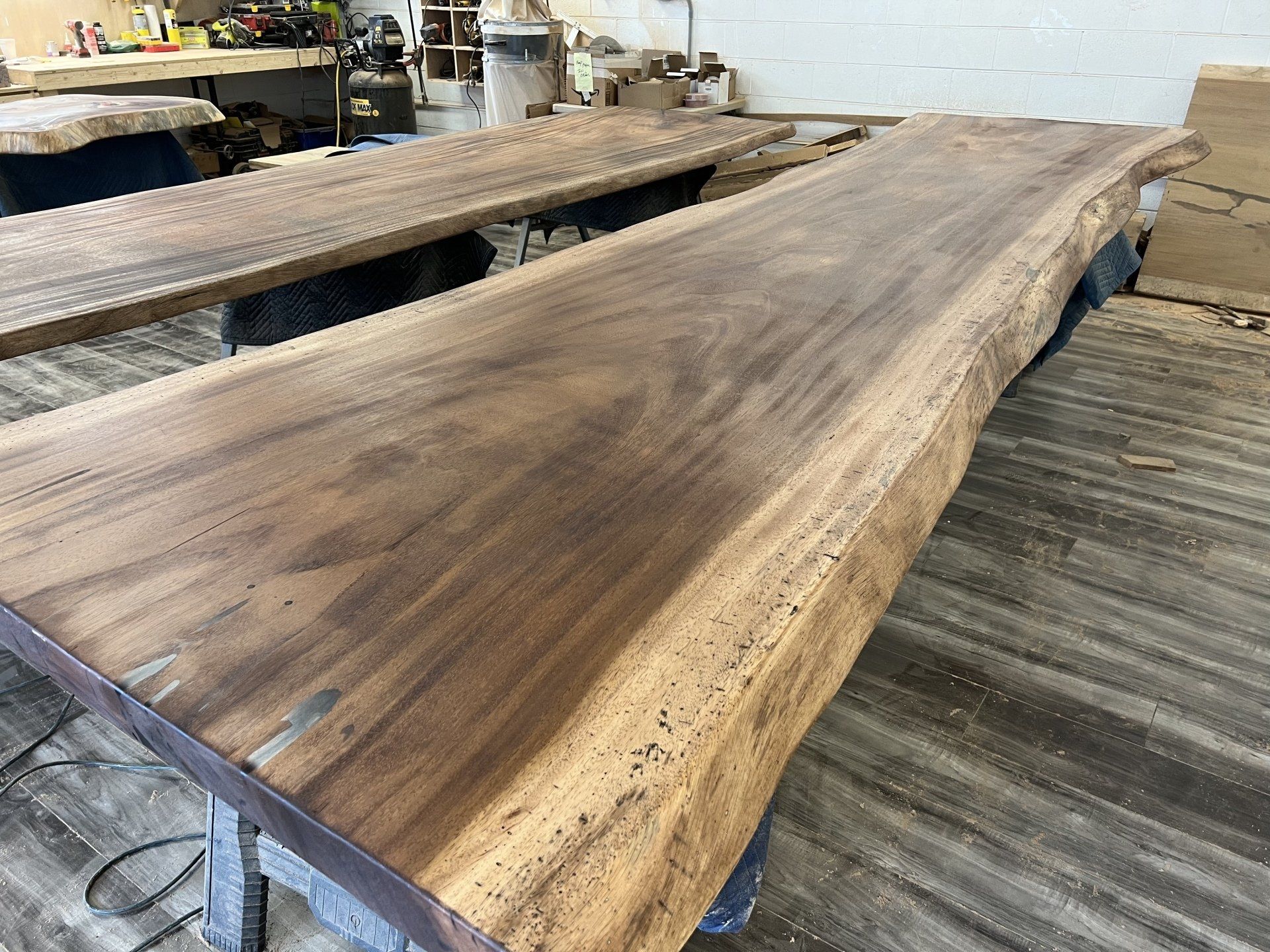 A large piece of wood is sitting on top of a wooden table.