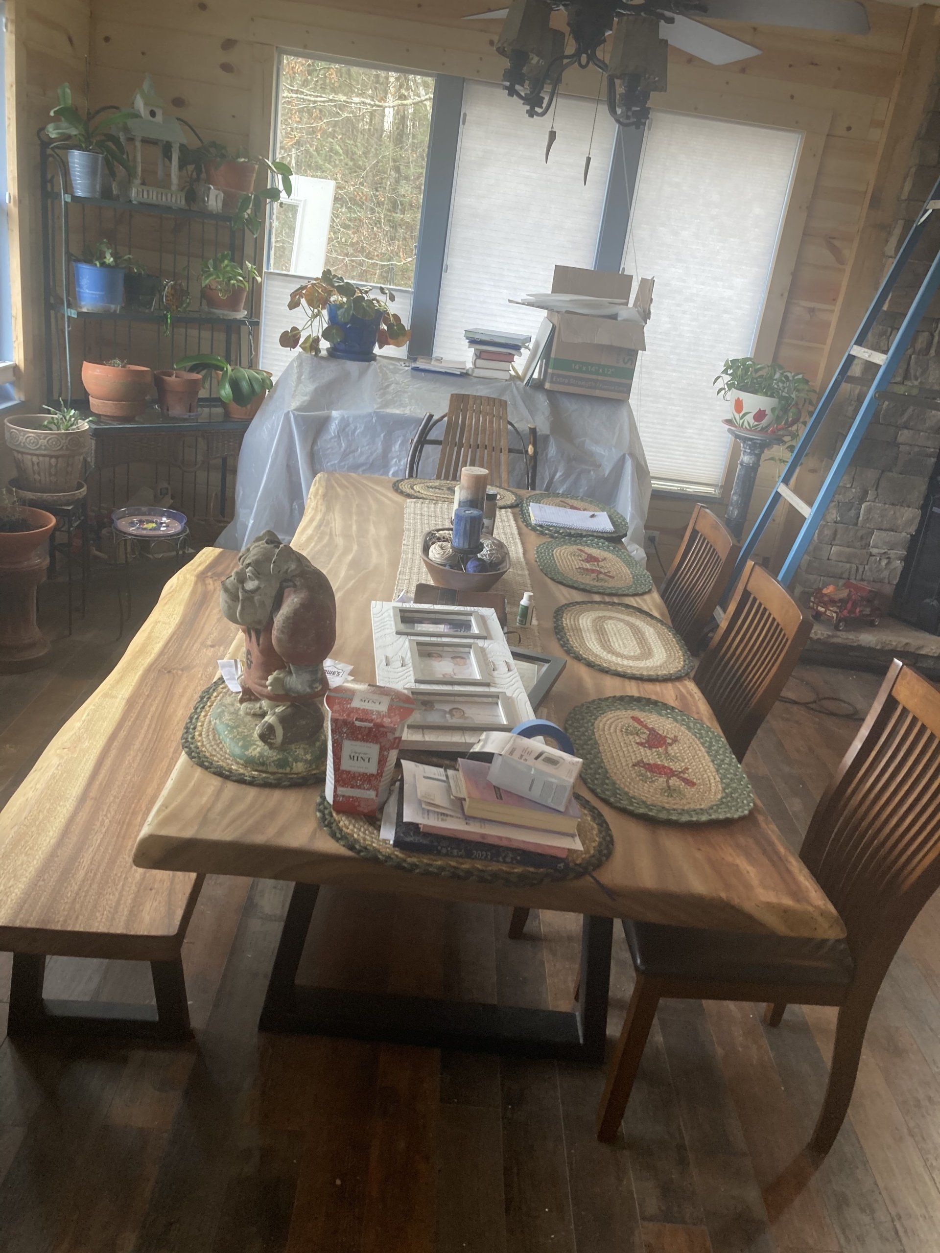 A dining room with a long wooden table and chairs.