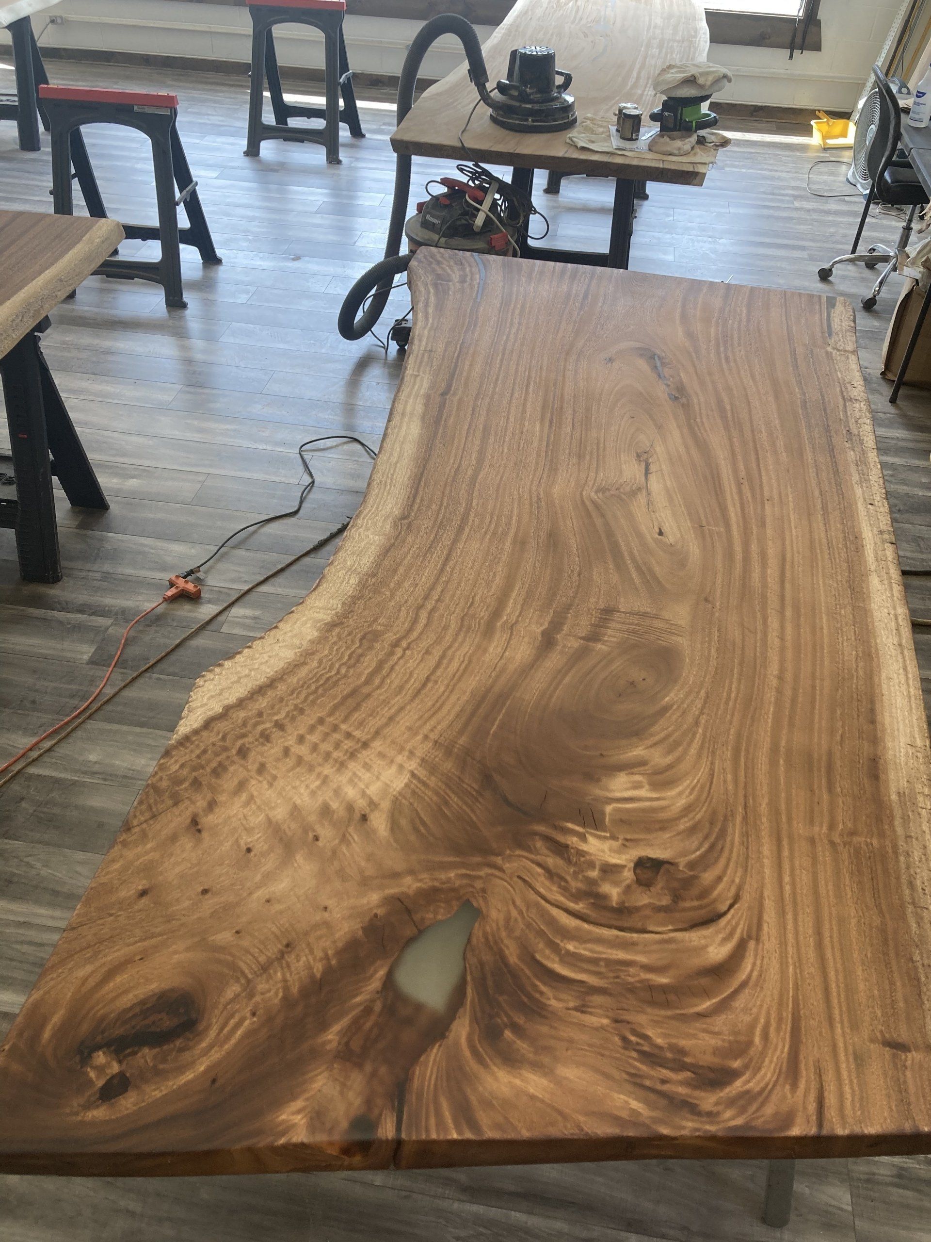 A large piece of wood is sitting on top of a wooden table.