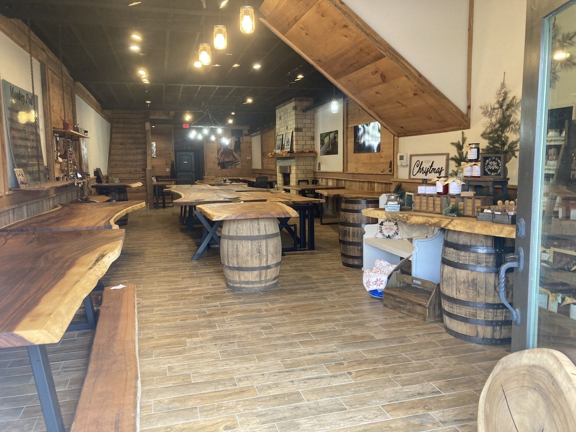 A large room filled with wooden tables and barrels.